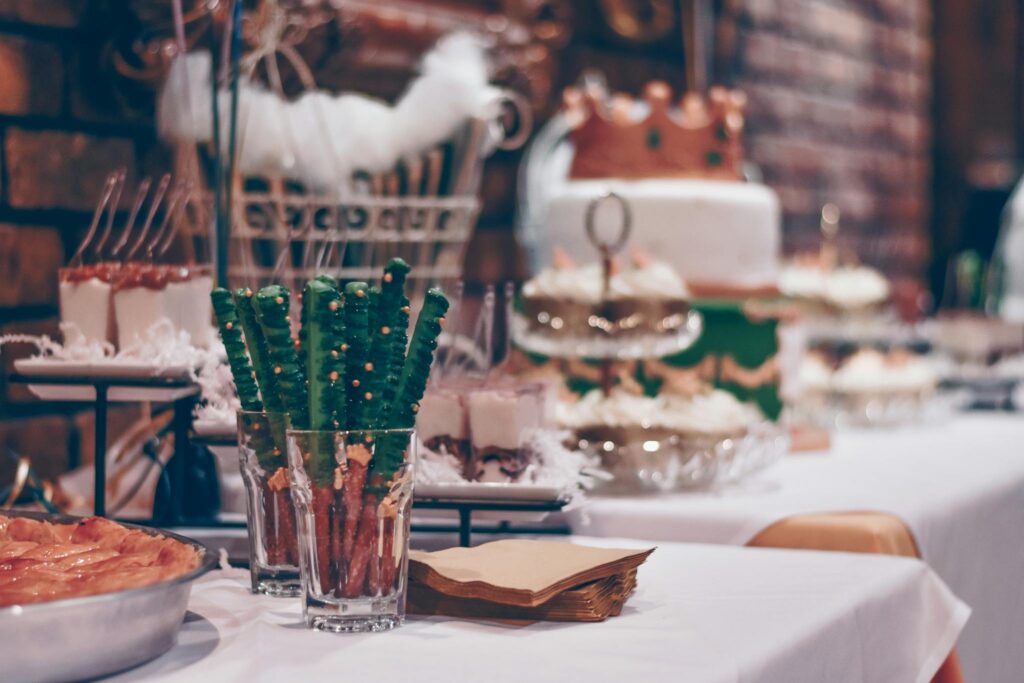 Baked Bread Beside Clear Drinking Glass on White Table Cover